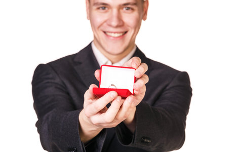 Groom gives the wedding ring in red box