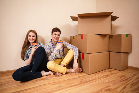 Relocated couple drinking tea on the floor