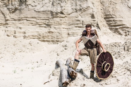 Fashion portrait of young man in desertの写真素材