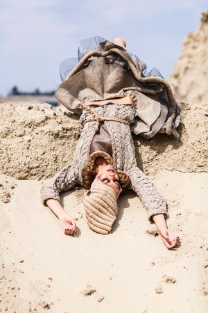Sexy woman lying in the sandの写真素材