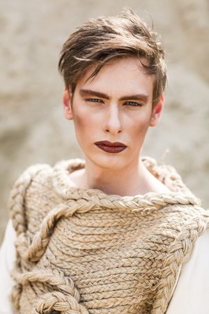 Attractive young man standing in a desertの写真素材