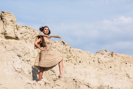 Fashionable young attractive and sensuality brunette woman in the desertの写真素材