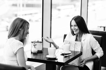 The young women with shopping bag in the cafeの写真素材