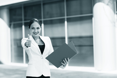 Portrait of young businessman giving thumb up gestureの写真素材