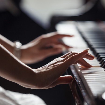Playing piano close up handsの写真素材
