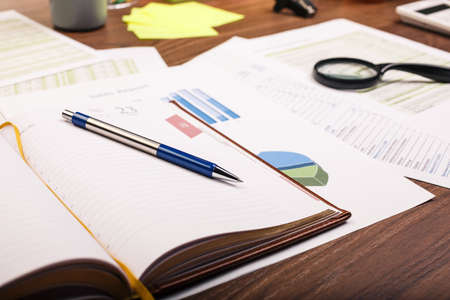 Office table. Desk office financial accounting graphs analysisの写真素材