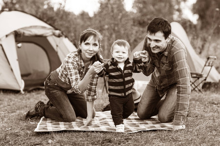 First steps. Baby learning to walk, with help of mothers and fathers hands.の写真素材
