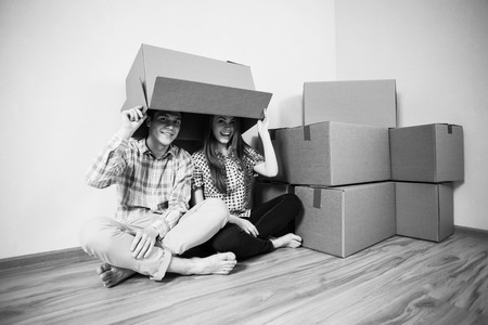 Couple with empty boxes on headsの写真素材