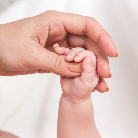 hands of the baby and mom
