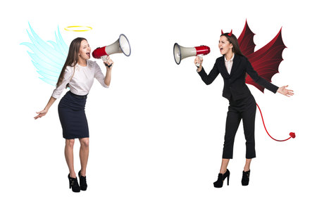 Portrait of angel and devil girls with megaphone and copyspace between them on white backgroundの写真素材