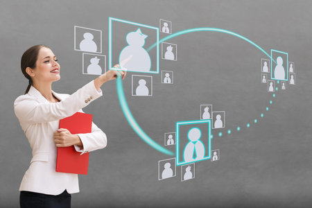 Interface, a woman on gray background pushing on virtual buttons.の写真素材