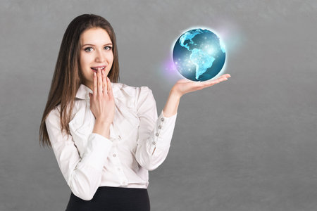 Portrait of surprised business woman on grey backgroundの写真素材