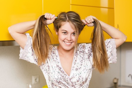 Young happy playful girl with two ponytails having fun and smilingの写真素材