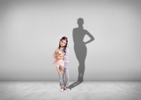 Child and shadow of successful adult on the backgroundの写真素材