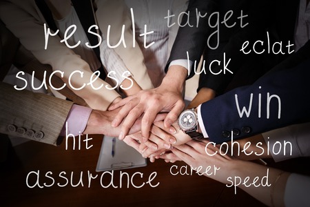 Team of  businessmen with folded hands, a symbol of teamworkの写真素材