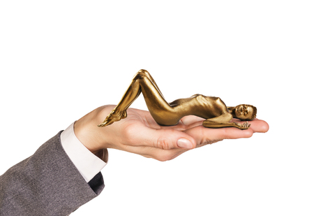 Open palm holds woman with gold skin on the white background.の写真素材
