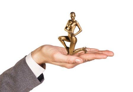 Open palm holds woman with gold skin on the white background.の写真素材