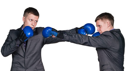 Serious businessman in sports boxing stance, isolated on the white backgroundの写真素材