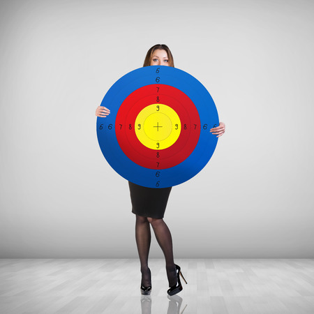Business woman holding big target . Success concept portrait.の写真素材