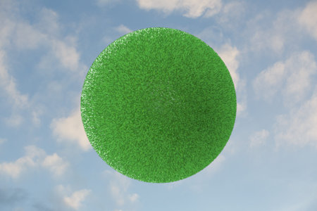Green grass sphere on a blue sky background