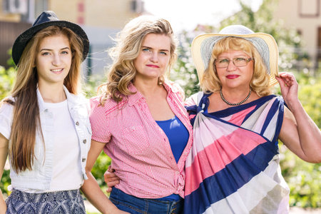 Grandmother ,mother and daughter  in the summer park