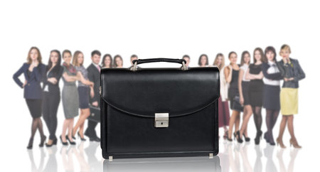 Black briefcase foreground and crowd of business peole isolated on the whiteの写真素材