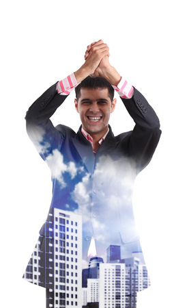 Happy young businessman enjoys victory, transparent on the city streetの写真素材
