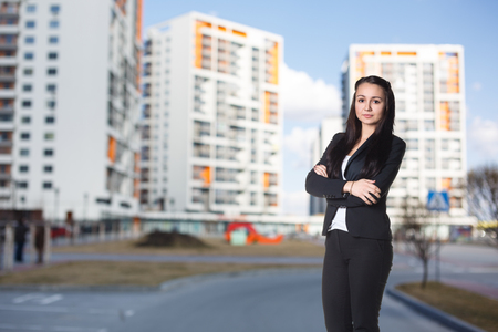 Businesswoman stands on the street in the cityの写真素材