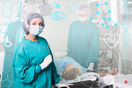 Team of surgeon in uniform perform operation on a patientの写真素材