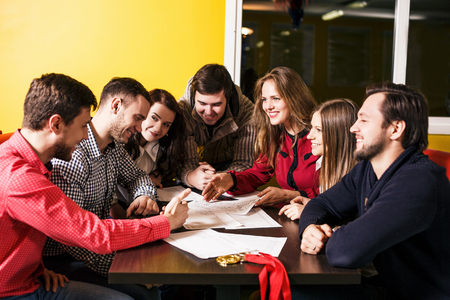 Friends discussing and brainstorming action plan at the tableの写真素材