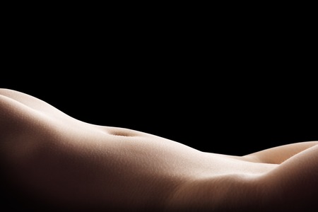 Perfect slim body of young woman isolated on blackの写真素材