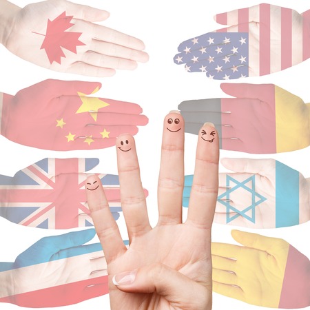 Many hands with different country flags painted on them isolated on whiteの写真素材