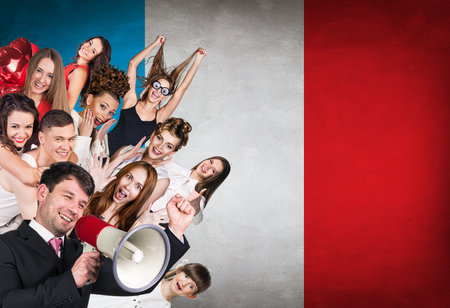 Happy group of diverse students standing on the chinese flag backgroundの写真素材