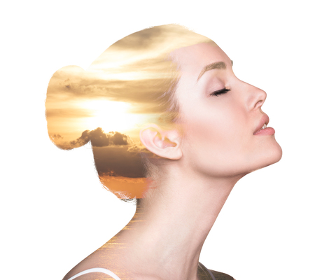 Double exposure portrait of a woman combined with photograph of natureの写真素材