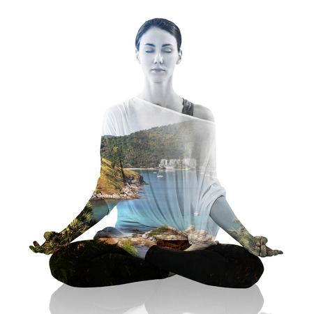 Double exposure portrait of woman in lotus position and natureの写真素材