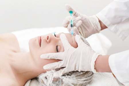 Young pretty woman receiving treatments in beauty salons. Contouring procedure , revitalization....