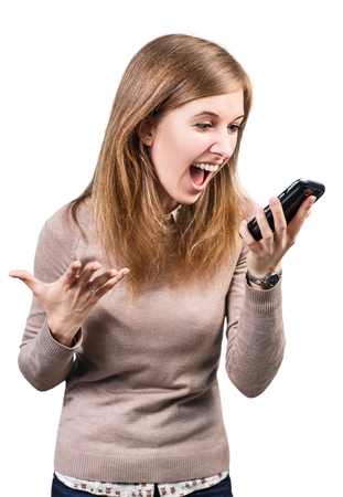 Angry businesswoman shouting on smartphone isolated on white backgroundの写真素材