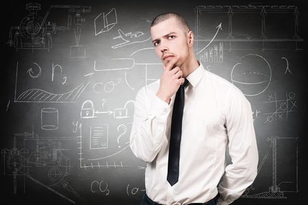 Young handsome man over school chalk board backgroundの写真素材