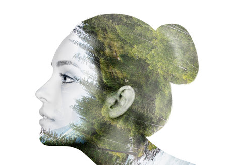 Double exposure portrait of a beautiful young woman and forest.の写真素材