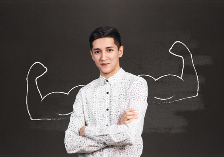 Young business woman with drawn powerful hands behindの写真素材