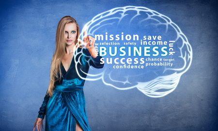 Fashion woman pointing on brain icon with business textの写真素材