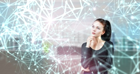 Young attractive woman standing in digital lights and lines.の写真素材