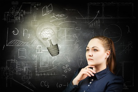 Woman and bright bulb over icons background.の写真素材