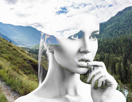 Portrait of young woman and nature landscapeの写真素材