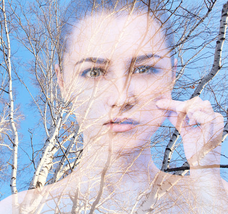 Double exposure of woman and tree branches.