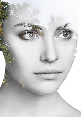 Double exposure of young woman and branches.の写真素材