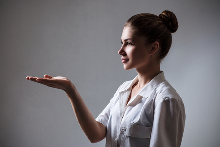 Medical doctor woman showing empty hand.の写真素材