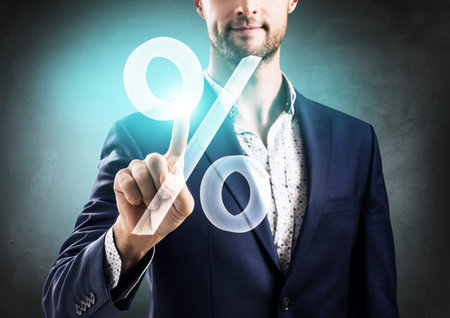 Businessman pushing big virtual percent.の写真素材
