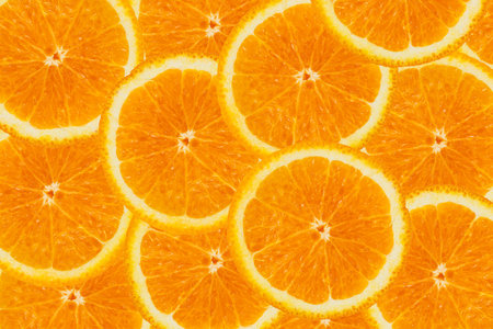 Bright background made of oranges slices.