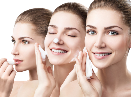 Young woman cleanses skin with foam and napkinsの写真素材